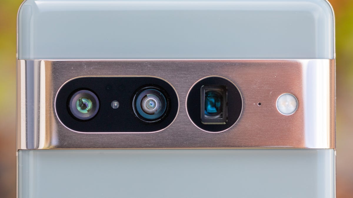 A closeup of the Google Pixel 7 Pro's three rear-facing cameras in the phone's shiny metal camera bar.