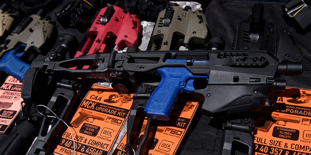 A MCK pistol brace for a handgun is displayed with firearm accessories for sale at the Crossroads of the West Gun Show at the Orange County Fairgrounds on June 5, 2021 in Costa Mesa, California.