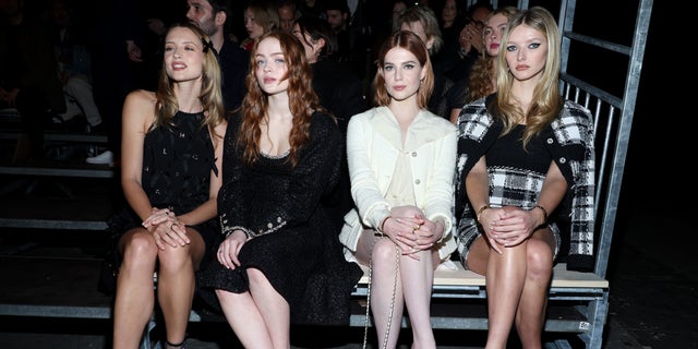 Apple Martin, right, was positioned front row with celebrity friends – Belgian singer-songwriter Angèle, "Stranger Things" star Sadie Sink and "Bohemian Rhapsody" actress Lucy Boynton.