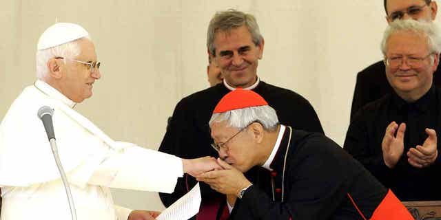 Chinese Cardinal Joseph Zen, right, Bishop of Hong Kong, kisses the hand of Pope Benedict XVI after the traditional Angelus prayer in Lorenzago di Cadore, Italy, on July 22, 2007. Zen will attend the funeral of Pope Bendecict XVI on Thursday.