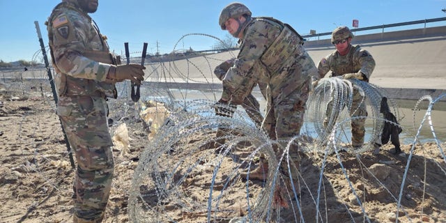 Texas National Guard installs razor wire long the border in an effort to stop immigrants from illegally crossing into the country from Mexico.