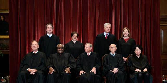 Members of the Supreme Court pose for a group photo at the Supreme Court in Washington, DC on April 23, 2021. Seated from left: Associate Justice Samuel Alito, Associate Justice Clarence Thomas, Chief Justice John Roberts, Associate Justice Stephen Breyer and Associate Justice Sonia Sotomayor, Standing from left: Associate Justice Brett Kavanaugh, Associate Justice Elena Kagan, Associate Justice Neil Gorsuch and Associate Justice Amy Coney Barrett. 