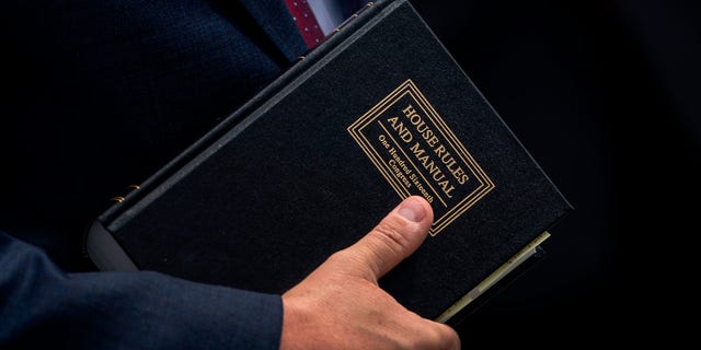 Rep. Mike Johnson, R-La., holds a House Rules and Manual book during a news conference outside the U.S. Capitol, May 27, 2020, in Washington, D.C.