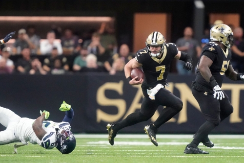 New Orleans Saints utility player Taysom Hill breaks the tackle of Seattle Seahawks safety Quandre Diggs and runs to the endzone for a 60-yard rushing touchdown during the Saints' 39-32 victory. Hill ran for three touchdowns, as well as throwing for another, as the Saints ended a three-game losing streak.