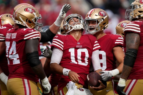 San Francisco 49ers quarterback Jimmy Garoppolo celebrates with his teammates during the second half of a 27-7 win against the Seattle Seahawks on September 18. Garoppolo came on as a substitute after starter Trey Lance went down for the year with a fractured ankle and threw for 154 yards and one touchdown -- and rushed for another -- on 13/21 passing.