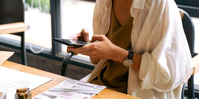 Photo of a woman presumably trying to access her phone after her SIM card was hacked.