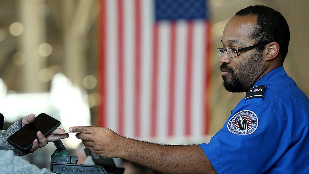 TSA agent taking driver's license.