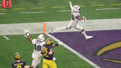 Bud Clark of the TCU Horned Frogs celebrates after returning an interception for a touchdown during the first quarter against the Michigan Wolverines.