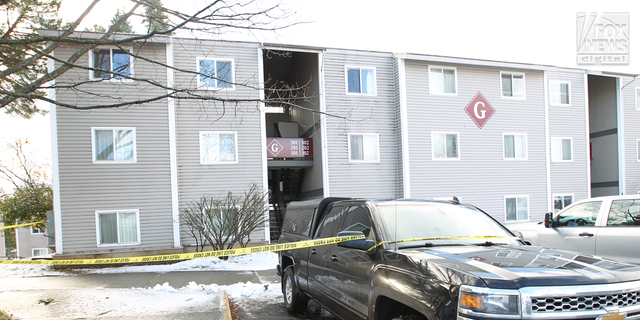 Crime scene tape surrounds an entrance to the Pullman apartment searched Friday morning.