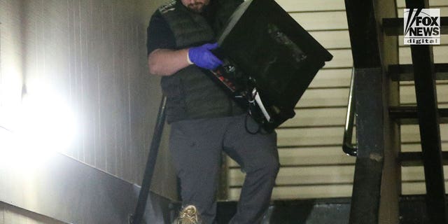 Investigators search Bryan Kohberger's home in Pullman, Washington, on Dec. 30. Among the items removed was a desktop computer and several boxes and bags of evidence.