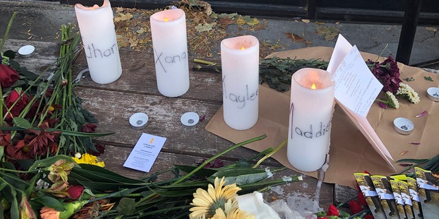 Candles and flowers are left at a makeshift memorial honoring four slain University of Idaho students outside the Mad Greek restaurant in downtown Moscow, Idaho, on Nov. 15.