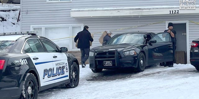 Police prepare to carry out victims' belongings from the house in Moscow, Idaho, on Dec. 7.