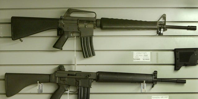 Assault-style rifles hang on display inside a Dallas, Texas gun shop, September 13, 2004. A 1994 law passed by Congress that outlawed the making and importing of certain military-style semiautomatic assault weapons and the manufacture of ammunition magazines containing more than 10 rounds is set to expire at midnight. Dallas gun dealers report more calls from the media concerning the weapons ban expiration than by gun enthusiasts trying to purchase the weapons. REUTERS/Jeff Mitchell  JM