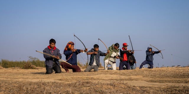 A group of local men practice archery on a ridge about 12 miles from Shillong, India, on Jan. 22, 2023. 