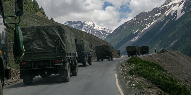 An Indian army convoy carrying reinforcements and supplies travels toward Leh through Zoji La, a high mountain pass bordering China June 13, 2021, in Ladakh, India.