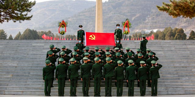 Soldiers of the local People's Armed Police Force pay respects to one of the four soldiers who died during a border clash with India in June 2020 at a martyrs' cemetery Feb. 24, 2021, in Lanzhou, Gansu Province of China.