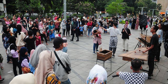 People gather at a public space after the Indonesian president announced the country will lift all remaining COVID-19 restrictions on Dec. 30, 2022. 