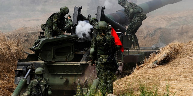 Soldiers reload a M110 self-propelled howitzer during a live-fire military exercise in Pingtung, Taiwan, on May 30, 2019.