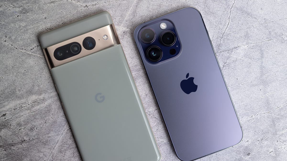 Google Pixel phone photographed next to Apple iPhone