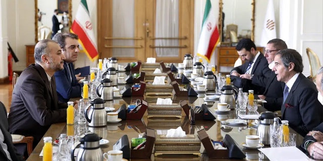 International Atomic Energy Agency Director-General Rafael Mariano Grossi, right, speaks with Iran's Foreign Minister Hossein Amirabdollahian, left, during their meeting in Tehran, Iran, March 5, 2022. 