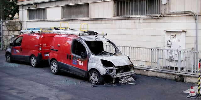 A damaged car remains parked on the streets of Rome following an attack claimed by an anarchist network on Jan. 30, 2023.