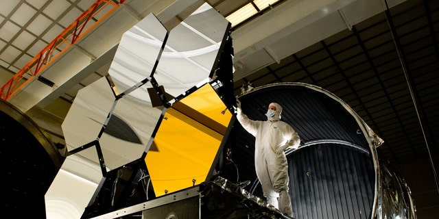 Ball Aerospace lead optical test engineer Dave Chaney inspects six primary mirror segments, critical elements of NASA's James Webb Space Telescope, prior to cryogenic testing in the X-ray &amp; Cryogenic Facility at NASA's Marshall Space Flight Center in Huntsville, Ala.