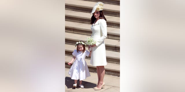 Catherine, Duchess of Cambridge leaves with her daughter Princess Charlotte after attending the wedding ceremony of Prince Harry and Meghan Markle at St George's Chapel, Windsor Castle, on May 19, 2018.