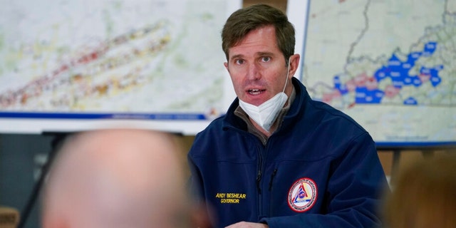Democratic Kentucky Gov. Andy Beshear speaks as he attends a briefing by local leaders on storm damage from tornadoes and extreme weather with President Biden at Mayfield Graves County Airport in Mayfield, Ky., Dec. 15, 2021.