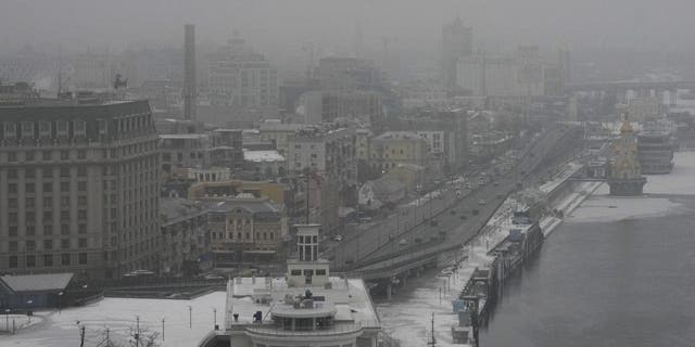 Fog covers Kyiv city center, Ukraine, Saturday, Jan. 14, 2023. A series of explosions rocked Kyiv on Saturday morning and minutes later air raid sirens started to wail as an apparent missile attack on the Ukrainian capital was underway. 
