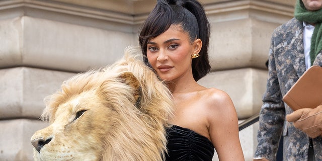 Kylie Jenner attended the Schiaparelli Haute Couture Spring Summer 2023 show during Paris Fashion week. Her dress featured a large embroidered head of a lion.