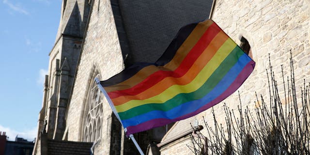 An LGBTQ+ flag flies over Union United Methodist Church in the South End of Boston on Jan. 5, 2020.