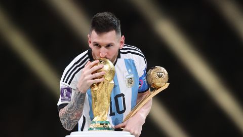 Lionel Messi kisses the World Cup trophy during the presentation ceremony. 