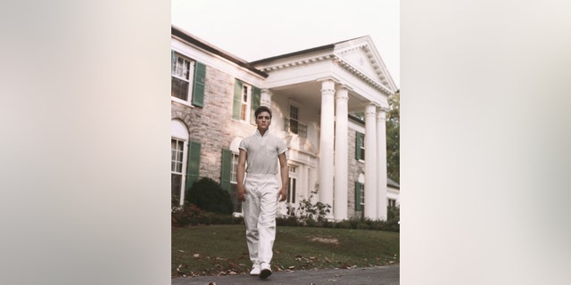Elvis Presley strolls the grounds of his Graceland estate in 1957. 