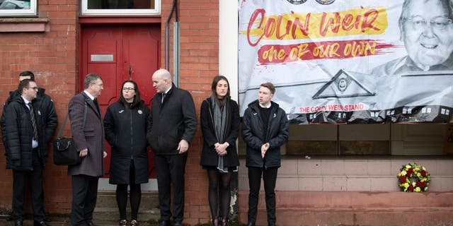 Partick Thistle staff and supporters outside Firhill stadium, where the funeral cortege of Colin Weir passed before the service at Partick Burgh Hall, Glasgow.