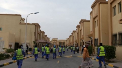 Foreign laborers working on the construction site of the Al-Wakrah football stadium, one of Qatar's 2022 World Cup stadiums, walk back to their accomodation at the Ezdan 40 compound after finishing work on May 4, 2015, in Doha's Al-Wakrah southern suburbs. 