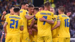 Ukraine's midfielder Andriy Yarmolenko is mobbed by teammates after scoring the opening goal during the FIFA World Cup 2022 play-off semi-final qualifier football match between Scotland and Ukraine at Hampden Park in Glasgow, Scotland on June 1, 2022. 