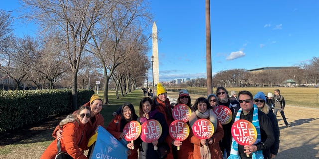 Actress Ashely Bratcher poses with members of Save the Storks at the 50th annual March for Life in Washington, D.C.