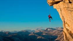 Jimmy Chin ascending a fixed line to the top of the Visor on Half Dome, Yosemite, California.