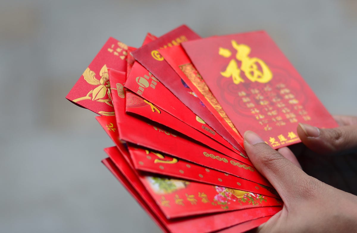 Woman holding red envelopes on Lunar New Year