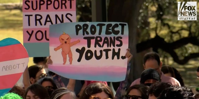 Demonstrators protest in support of rights for transgender youth.