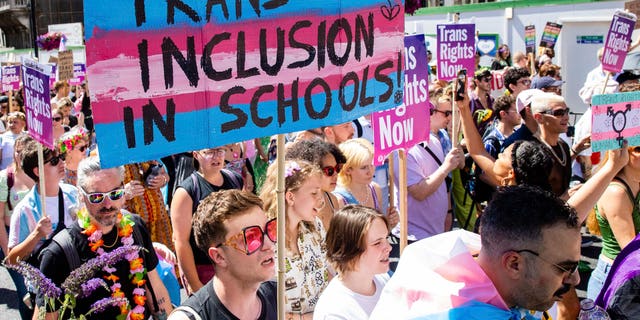 A protester voices support for the promotion of transgender ideology in schools during a pro-transgender march in October 2022.