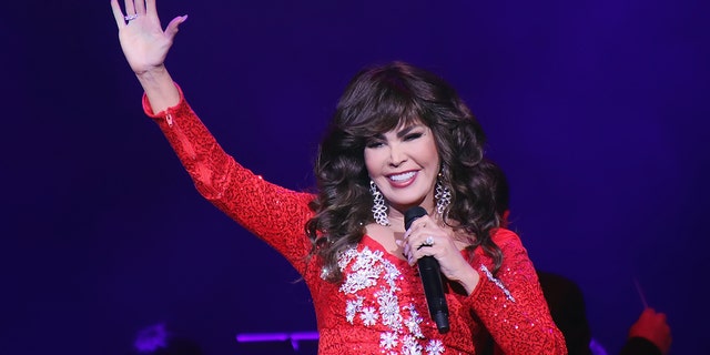 Marie Osmond's signature brown locks were covered by a wig at Disney World.