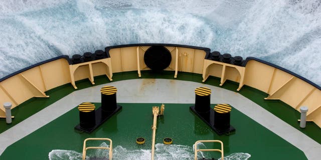 The bow of the icebreaker Kapitan Khlebnikov pushes through a wave in rough seas while crossing the Drake Passage.