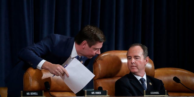 Rep. Eric Swalwell (D-CA), left, confers with committee chairman Rep. Adam Schiff (D-CA) as they listen to former National Security Council Senior Director for European and Russian Affairs Tim Morrison and former State Department special envoy to Ukraine Kurt Volker testify before the House Intelligence Committee in the Longworth House Office Building on Capitol Hill Nov. 19, 2019 in Washington, D.C.