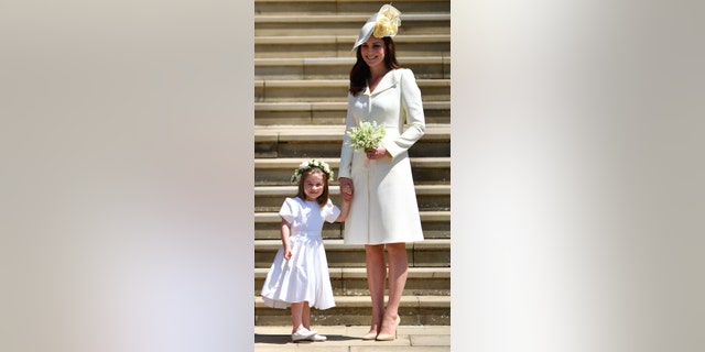 Princess Charlotte, left, and her mother, the Princess of Wales, leave the wedding ceremony of Britain's Prince Harry, Duke of Sussex and American actress Meghan Markle at St George's Chapel, Windsor Castle, in Windsor, England, on May 19, 2018.