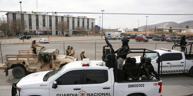 Mexican National Guard stand guard outside a state prison in Ciudad Juarez, Mexico on Sunday. Mexican soldiers and state police regained control of a state prison in Ciudad Juarez across the border from El Paso, Texas after violence broke out, according to state officials. 