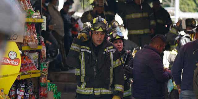 Rescue workers exit the Raza station in Mexico City where two subway trains collided on Jan. 7, 2023. Mexican authorities announced that another person has died and more than a dozen people were injured in the accident.