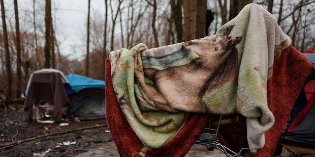 CALAIS, FRANCE - DECEMBER 31: Migrants coming from African and Middle-Eastern countries continue their lives at make-shift tents under harsh conditions amid winter cold at Grande-Synthe of Calais, on the northern French coast on December 31, 2022. Migrants who illegally arrived in France with a hope of better life have been waiting here for weeks and months to enter the UK after crossing the English Channel.