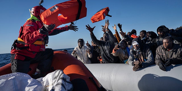 Migrants and refugees from Africa sailing adrift on an overcrowded rubber boat, receive life jackets from aid workers of the Spanish NGO Aita Mary in the Mediterranean Sea, about 103 miles (165 kms.) from Libya coast on Jan. 28, 2022. The number of attempts by migrants to enter the European Union without authorization reached around 330,000 last year, the highest number since 2016, the EU’s border and coast guard agency said Friday, Jan. 13, 2023.