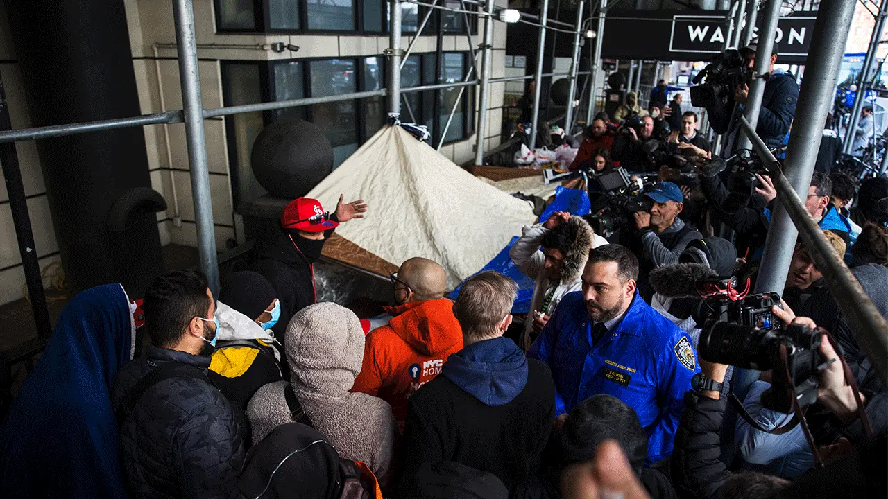  Migrants speak with NYC Homeless Outreach members as they camp out in front of the Watson Hotel after being evicted on January 30, 2023 in New York City. 